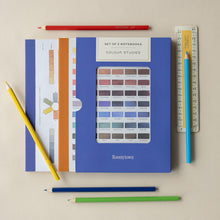 Load image into Gallery viewer, Set of 2 notebooks with color swatches, colored pencils, and a ruler on a beige background