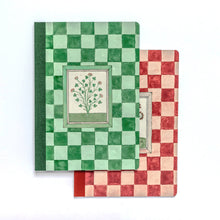 Load image into Gallery viewer, Two patterned notebooks or journal covers stacked on a white background. The top cover has a green and light green checkerboard pattern with a central botanical illustration panel.