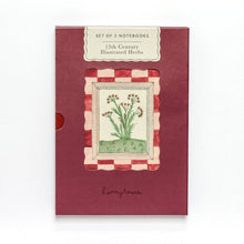 Load image into Gallery viewer, A set of two notebooks in a vintage-style illustrated card sleeve. The sleeve is dark red with a central illustration of a 15th-century herb plant in a striped frame, and a label at the top reads 'SET OF 2 NOTEBOOKS - 15th Century Illustrated Herbs'.