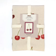 Load image into Gallery viewer, A folded cotton tea towel with a cherry print, wrapped in a cream elastic band and a paper label tag that reads 'TEA TOWEL ORGANIC COTTON CERISIER' BY 'Roomytown'.