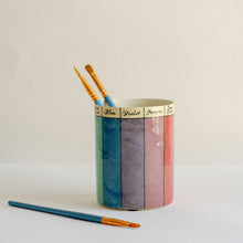 Load image into Gallery viewer, Colorful cylindrical container with paintbrushes on a light background