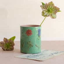 Load image into Gallery viewer, Green vase with floral design on a beige surface