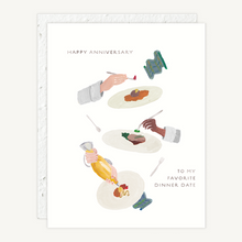 Load image into Gallery viewer, A white anniversary greeting card with illustrated hands serving food on plates, accompanied by the text 'HAPPY ANNIVERSARY' and 'TO MY FAVORITE DINNER DATE'. A matching white textured envelope is visible behind the card.