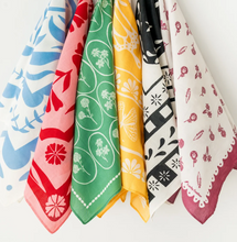 Load image into Gallery viewer, Six patterned square bandanas in pink, green, yellow, black, and white hanging side by side against a plain white background.