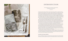 Load image into Gallery viewer, Book page with a photograph of a table setting and text on a white background