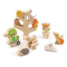 Load image into Gallery viewer, stacking garden friends play set from tender leaf toys featiring shaped wooden pieces that can be stacked and arranged in and around a wood tree base. shapes include a snail, mouse, bird, squirrel, turtle, cat, dog, fox, rabbit, porcupine, wheelbarrow with plants, and flower pot