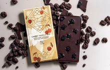 Load image into Gallery viewer, 70% Dark Chocolate Cherry Vanilla Bar package aside and unwrapped chocolate bar, showing embedded tart dried cherries within the chocolate.