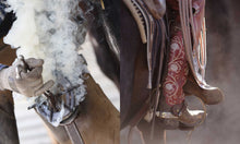 Load image into Gallery viewer, Close-up of a horse saddle with decorative elements and a gloved hand holding a tool.