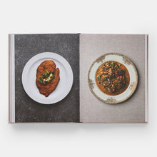 Load image into Gallery viewer, An open cookbook showing two plated dishes on spread pages against a light gray background.