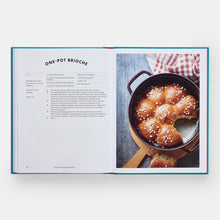 Load image into Gallery viewer, Open cookbook showing a recipe for one-pot brioche with a photo of the dish on a white background.