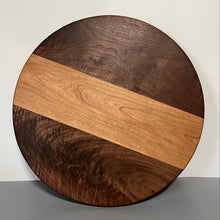 Load image into Gallery viewer, Round wooden cutting board with a two-tone design on a plain background
