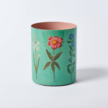 Load image into Gallery viewer, Teal cylindrical container with floral illustrations on a white background
