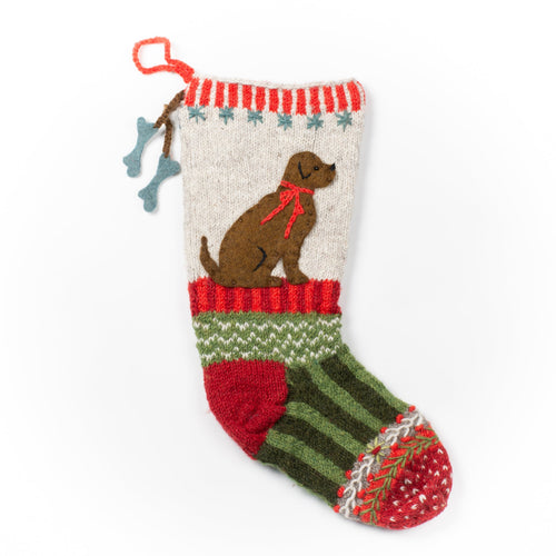 100% hand knit wool scarf made in Nepal by New Horizons. Features a brown lab with a red bow collar, two bone tassels, snow flakes, festive design, green and white zig zags with red and maroon stripes