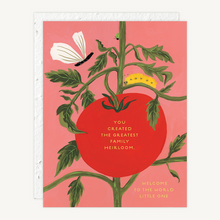Load image into Gallery viewer, A greeting card featuring an illustration of a tomato plant with a large red tomato, green leaves, a white flower, and a yellow caterpillar on a pink background. The card has gold text reading 'YOU CREATED THE GREATEST FAMILY HEIRLOOM.' and 'WELCOME TO THE WORLD LITTLE ONE'
