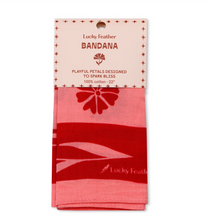 Load image into Gallery viewer, A folded Lucky Feather bandana in shades of pink and red, presented on its original printed hanger card against a plain white background.
