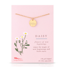 Load image into Gallery viewer, A gold daisy necklace with a round engraved pendant displayed on a pink card. The card features a botanical illustration of daisies, the word 'DAISY', and text reading 'flowers of new beginnings' and 'enjoy the magic of new beginnings and fresh starts'.
