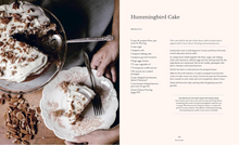 Load image into Gallery viewer, A recipe spread sheet for Hummingbird Cake, featuring a close-up photo of a layered cake on the left and the printed recipe instructions on the right, styled with a spoon, chocolate chips, and whipped cream.
