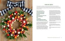 Load image into Gallery viewer, A printed recipe book or magazine spread showing a festive charcuterie-wreath food arrangement on the left page and recipe text on the right page, with a black-and-white gingham bow placed on top of the wreath.
