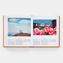 Load image into Gallery viewer, Open book showing two images of pink roses with a scenic background.
