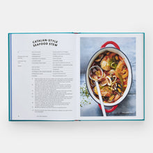 Load image into Gallery viewer, Open cookbook showing a recipe for Catalan-style seafood stew with an image of the dish on a white background.

