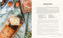 Load image into Gallery viewer, A recipe spread sheet for 'Anadama Bread' featuring a rustic photograph of freshly baked sourdough loaves and eggs on the left, and the recipe text and ingredients listed on the right.
