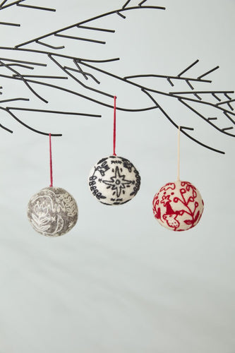 felted ball ornament with grey base and white felted embroidery design