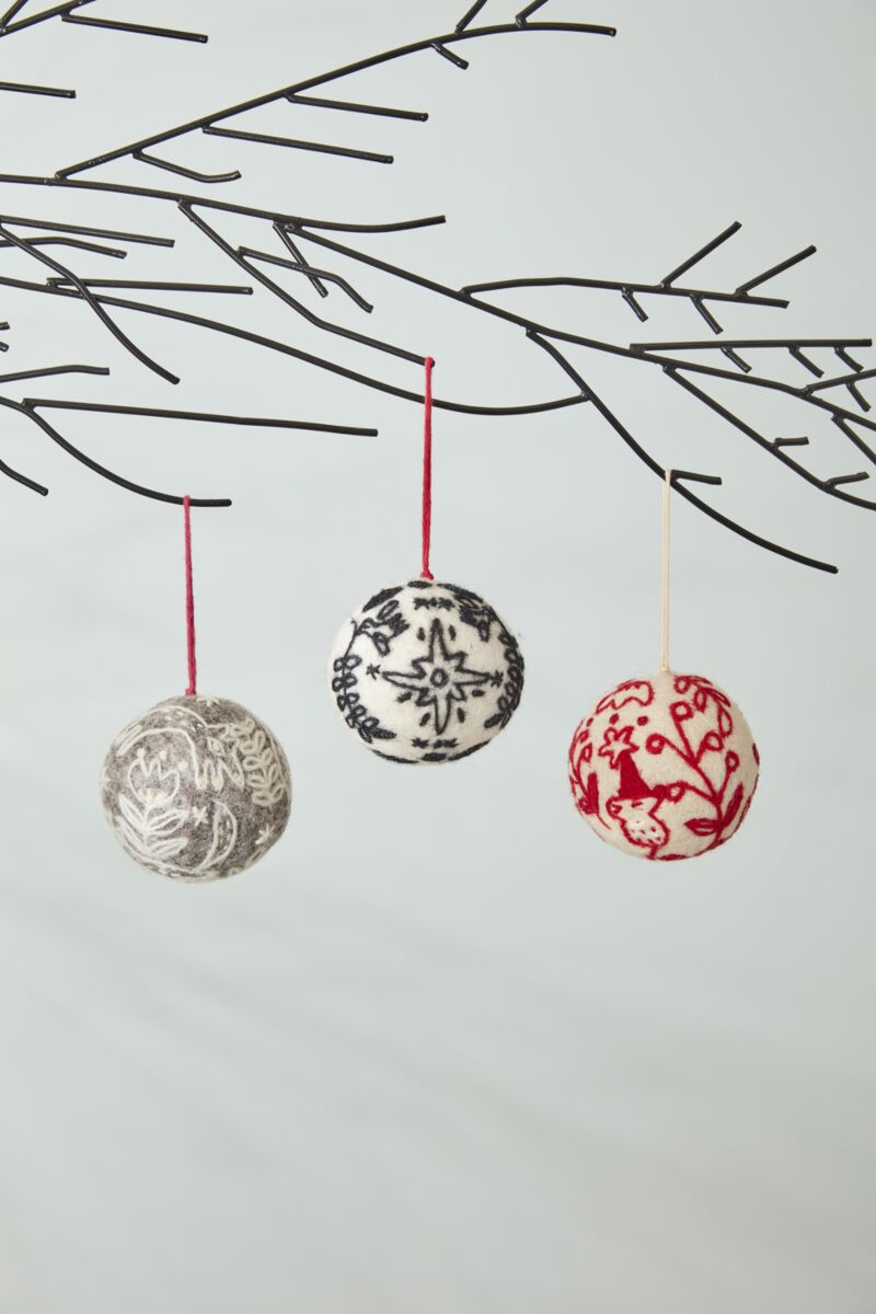felted ball ornament with grey base and white felted embroidery design