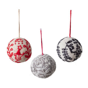 felted ball ornament with black base and white felted embroidery design