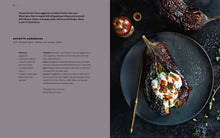 Load image into Gallery viewer, Stuffed eggplant dish on a dark plate with text on the left side.
